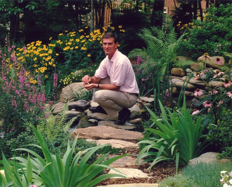 Lush perennials soften edge of pond with perennials